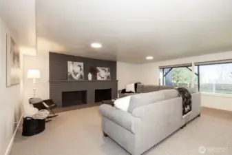 Lower Level Living Room- Fireplace recently painted with new custom sandstone hearth.