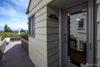 Exterior view of the kitchen door, with the front deck beyond.