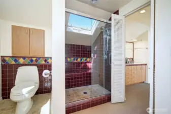 Primary bath, with skylight. To the right there are dual sinks.