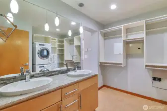 Primary bath with Marmoleum flooring, granite countertop and attractive tile backsplash.