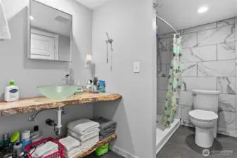 Stylish tile, live edge vanity, vessel sink, large shower w shaving bench and so much more.