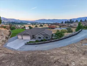 Aerial view of home on spacious lot overlooking Lake Chelan.