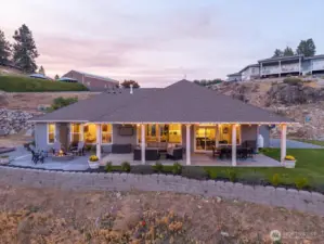 Twilight view of home and outdoor living area.
