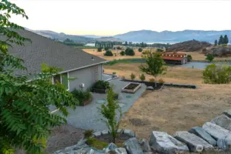 View of side yard with raised garden beds and lake views.