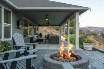 Outdoor living area with fire pit, outdoor dining, lounge and BBQ areas overlooking Lake Chelan.