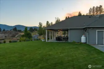 Exterior view of grassy yard and outdoor living area.