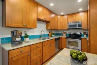 Virtually staged kitchen. Lots of counter space, storage and even a bar to put stools under for dining.