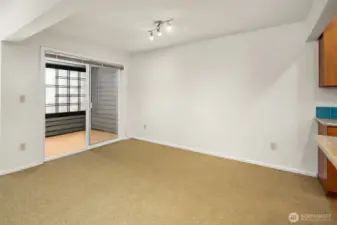 Un-staged dining space with slider to enclosed porch. Porch was formerly used as an office.