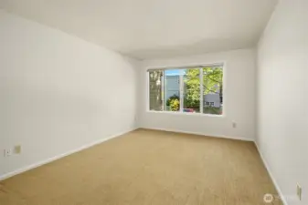 Un-staged bedroom with updated vinyl windows.