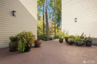 Communal patio area with planters. Lawn cushions are put away for the season but this is a place where neighbors gather.