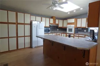 Check out all the cabinets in this kitchen. Notice the eating bar too.