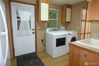 Back door from covered breezeway to laundry room. Sink, w/d and freezer stay.