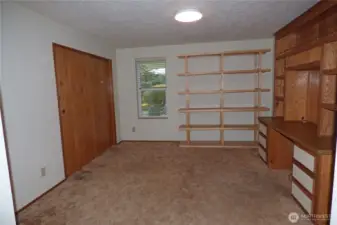 Den plus closet or 3rd bedroom with built in desk. Window overlooks back patio.