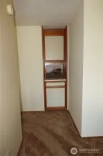 Hall to bedrooms with a little storage area.