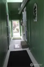 Covered breezeway to the garage and driveway. Notice the door at the end for wind and weather protection. The other end leads to the covered patio.