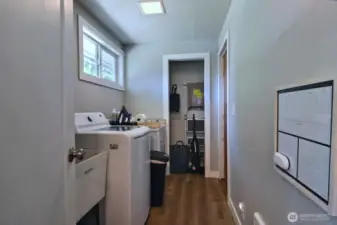 laundry room off of the kitchen with storage and door leading to the garage. This was considered being converted to a second bathroom