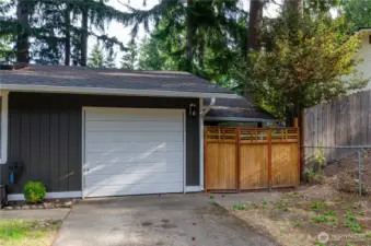 Garage Door and Extra Storage Area. Could be used as additional Covered Parking