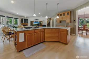 Island features gas cooktop, prep sink, cupboards galore, and seating for at least 6