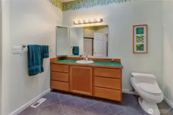 Full bath down this wing also has plenty of elbow room and unique glass etching of foliage on the showing door