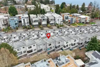 This shows the back of the townhome with the garage entrance. The 2-car attached garage has a new electric panel to support EV charging along with a nice storage area and tankless water heater for instant hot water.