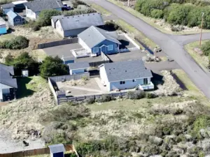 Partially fenced back yard with shed for tools and toys.