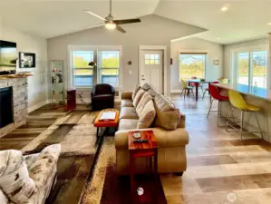 Sun-drenched great room featuring vaulted ceilings