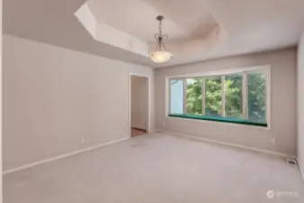 The Bay Window and Coffered Ceiling add so much Character to this Office / Dining Room or  Large Den next to a  Hallway that passes the Dry Bar and into the Kitchen