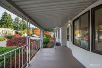 Your quiet and covered front porch to enjoy all the seasons, stay in touch with neighbors and stay dry!