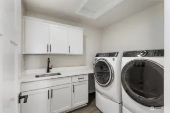 Large utility room with storage and sink.