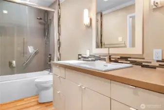 A Spacious Hallway Bathroom Featuring Elegant Tile Details
