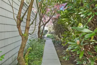 Meandering paths and vibrant gardens invite exploration, revealing delightful surprises at every turn, creating an enchanting experience throughout the property.
