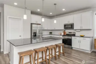 Sparkling quartz countertops, and an oversized chef's island