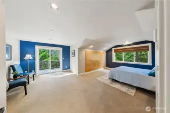 The loft level primary bedroom has an exterior door to a private deck, and stairs down to the yard.