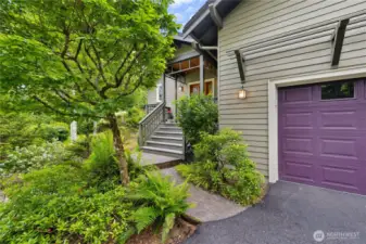 Access to the front entry deck, garage and driveways, softened by beautiful plantings.