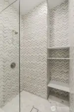 Marble Tile in the walk-in shower and floating glass.