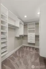 Walk-in primary closet with custom built-ins.