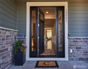 From the front entry, you can see the French doors to the cozy living room and then to the greatroom beyond.
