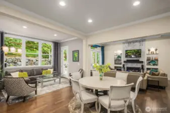 The great room has so many different spaces and walls of glass taking in the natural light and greenscape.