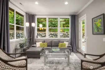 This sitting area lets light in from 3 directions - a perfect place to curl up with a book or enjoy conversation with friends.