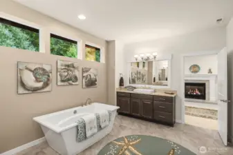 The primary bath features a separate soaking tub, two vanities, a generous two-headed shower and large walk-in closet.