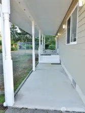 Covered concrete walkway leads to the Front Entry.