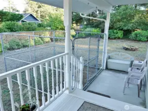 Covered Front Deck steps down to the Patio and Fenced Dog Area.