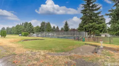 Horseshoe pit with secured RV parking in the background.