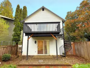 Backyard with deck, spiral staircase and patio