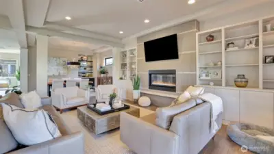 o Custom built-ins with shelves, media cabinet, accent lighting, and more.  o Open to Kitchen and Dining / Entertaining space with Wet Bar  o Featuring a modern, horizontal gas fireplace   o Look for the custom modern, glass art window that matches the style of the home