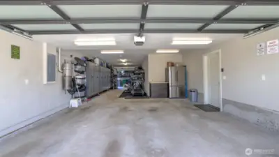 o Oversized three-car tandem garage.  o Partially finished shop area with lots of storage  o Covered patio with water and electrical behind the garage.  o The garage and shop are outfitted with Gladiator wall panels and slats to support a custom cabinet configuration. The buyer to provide the cabinets and accessories.