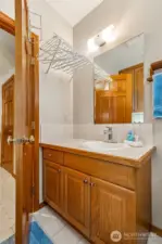 Convenient lower-level powder room combined with a functional laundry space.