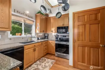 Function and beauty converge in this updated kitchen with sleek granite counters, and updated appliances.