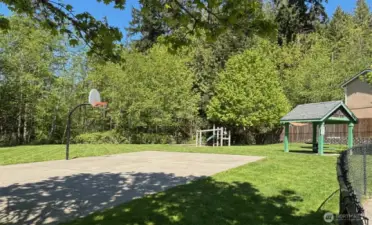 Community playground with basketball court, picnic shelter and jungle gym