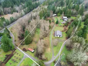 Drone view of land, showing small barn lower left corner .